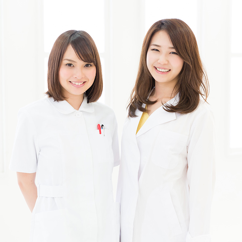 Two home care nurses wearing white uniforms